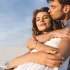 smiling-young-couple-hugging-beach-178302327